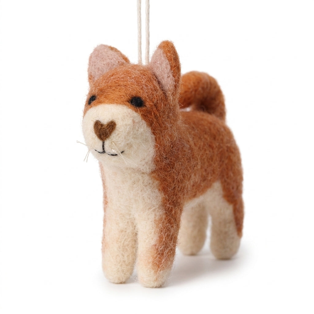 Handmade wool felt orange cat ornament with hanging thread on a white background
