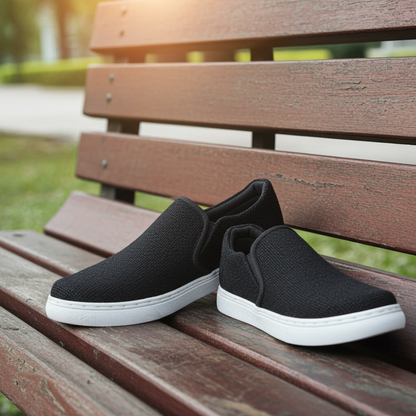 Black pure hemp -on shoes with white soles on a wooden bench outdoors.
