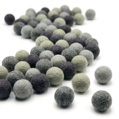 Collection of gray  felt balls for crafts and kids diy projects on a white background