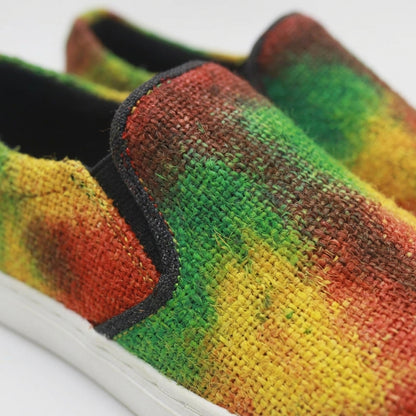 Colorful  tye dye hemp slip-on shoes with a pattern of green, orange, and yellow on a white background.Eco - Friendly Tie Dye Rasta Hemp Slip - On Sneakers | Handmade Vegan Unisex Festival Shoes Bright_Hues_Footwear