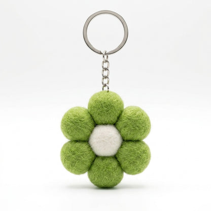 Green wool felt large flower keyring with white centre on a white background