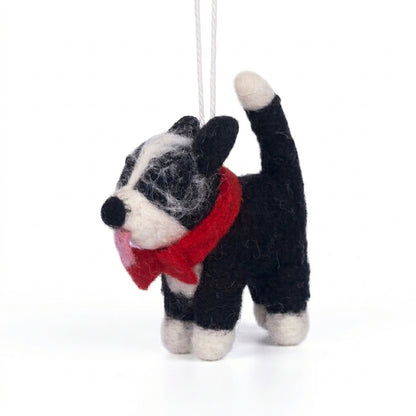 Handmade wool felt Border Collie dog ornament with black and white markings with a red scarf on a white background