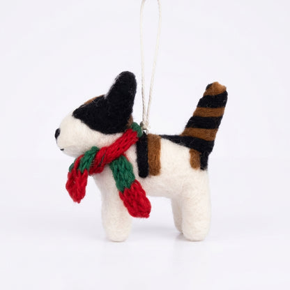 Handmade wool felt black and white cat ornament with hanging thread with a red and green scarf on a white background