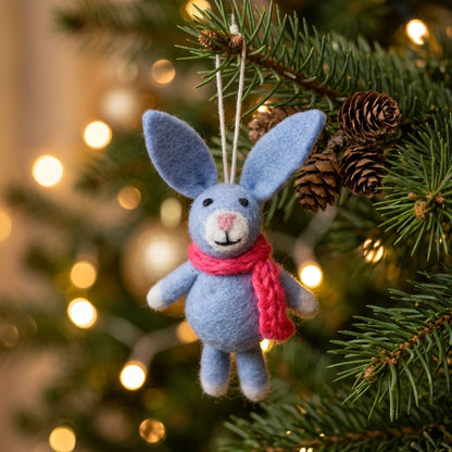 Handmade wool felt bunny ornaments in assorted scarf designs on a Christmas tree.