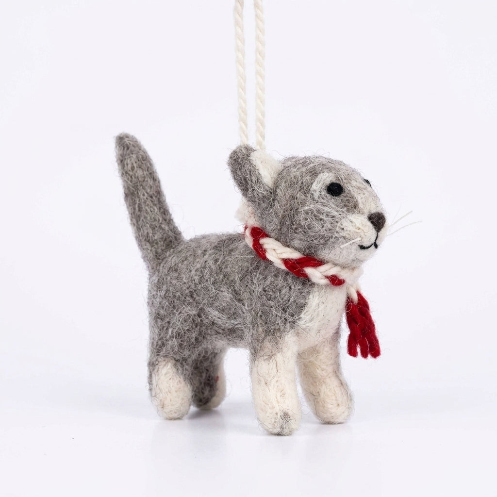 Handmade wool felt calico cat ornament with hanging thread on a white background