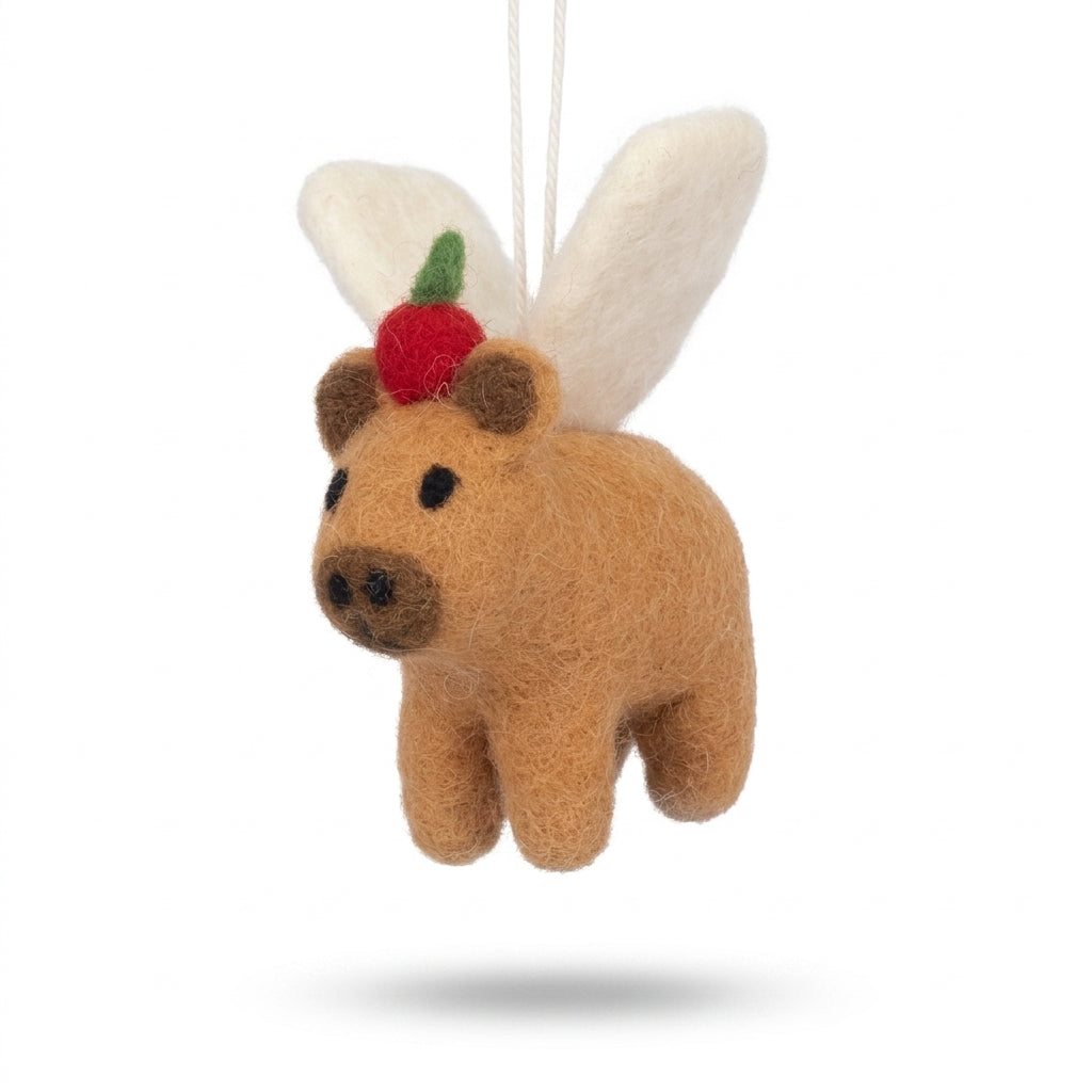 Handmade wool felt poodle dog ornament with classic grooming details resembling a bear with bunny ears and a carrot on a white background
