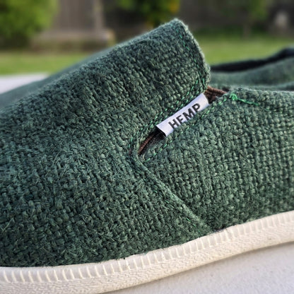 Close-up of natural rubber sole hemp shoes handmade sustainable footwear with a blurred outdoor background.