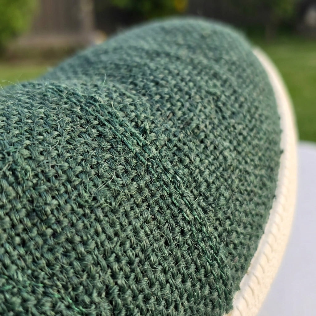Close-up of natural rubber sole hemp shoes handmade sustainable footwear with a blurred outdoor background.