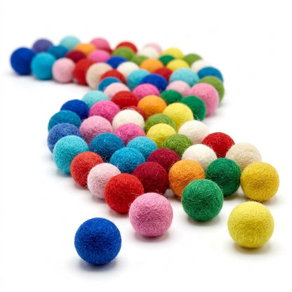 Multicolored felt balls for crafts and kids diy projects on a white background