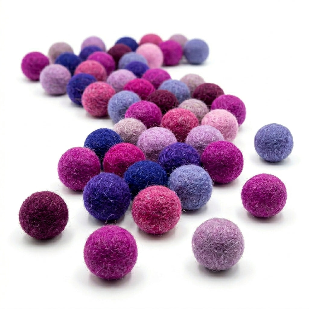 purple felt balls for dity projects and crafts on a white background