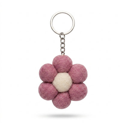 Small pink felt flower keychain with metal keyring on a white background