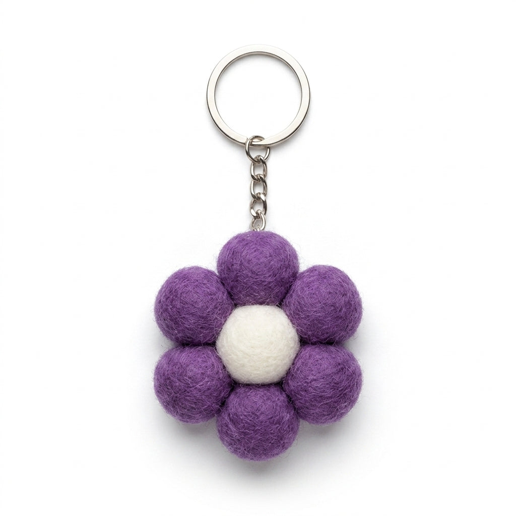 Small purple felt flower keychain with metal keyring keychain with a white center on a white background