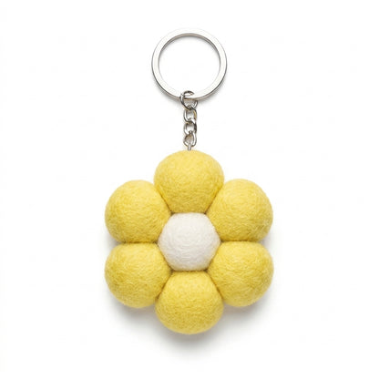 Yellow wool felt large flower keyring with white centre with a white center on a white background