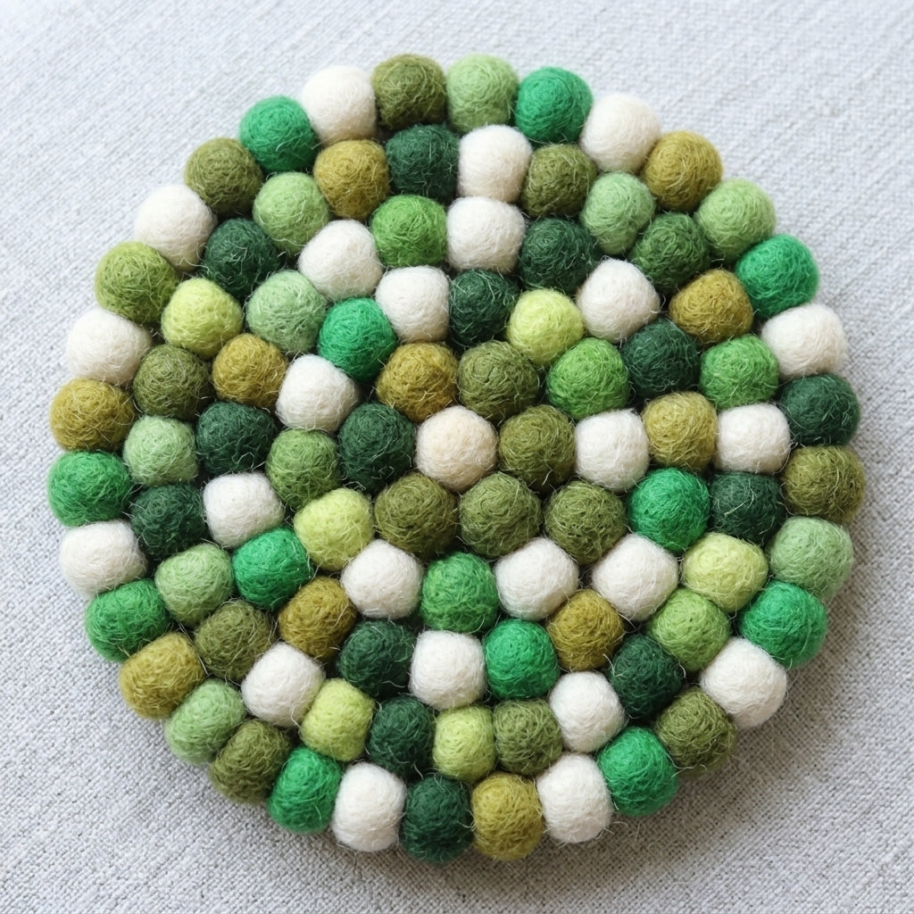 RoundForest Mix Green wool felt coasters handmade in Nepal, botanical absorbent non-scratch drink coasters for wooden tables, plant lover gifts, host gifts and new home buyers on a light gray background