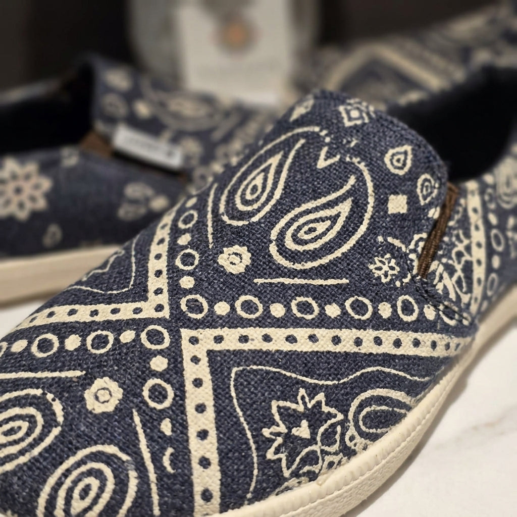 mandala pattern hemp slip-on shoes with white paisley pattern on a blurred background