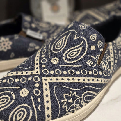 mandala pattern hemp slip-on shoes with white paisley pattern on a blurred background