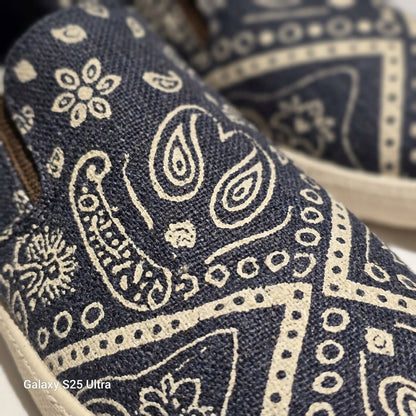 Close-up of blue fabric with white paisley pattern