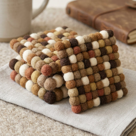 Stack of woven coasters with a mug and book in the background