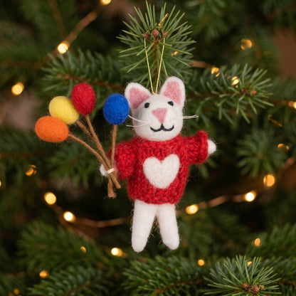 White wool felt mouse ornament holding colourful balloon with colorful balloons on a Christmas tree.