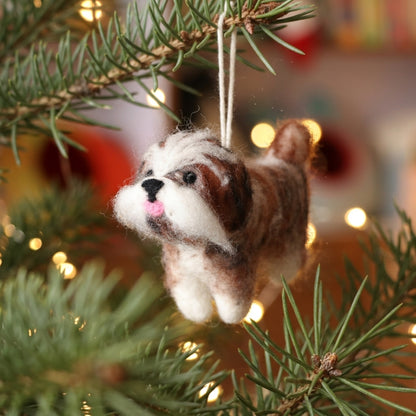 Handmade wool felt Shih Tzu dog ornament with hanging thread Christmas ornament hanging on a tree with blurred lights in the background
