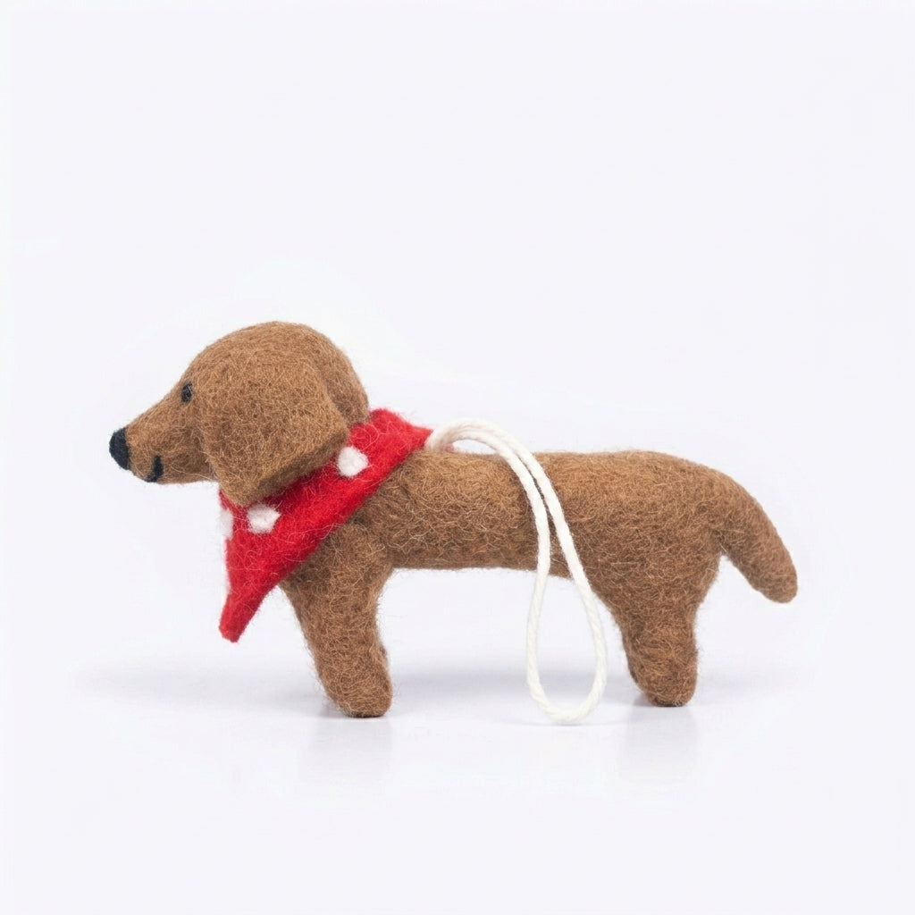 Handmade wool felt dachshund dog ornament with red collar on a white background