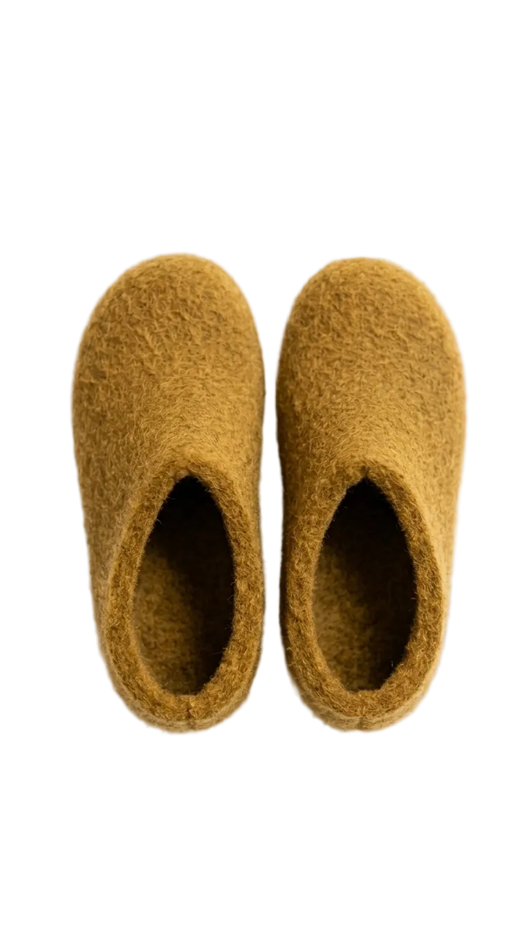Pair of mustard yellow slippers on a white background